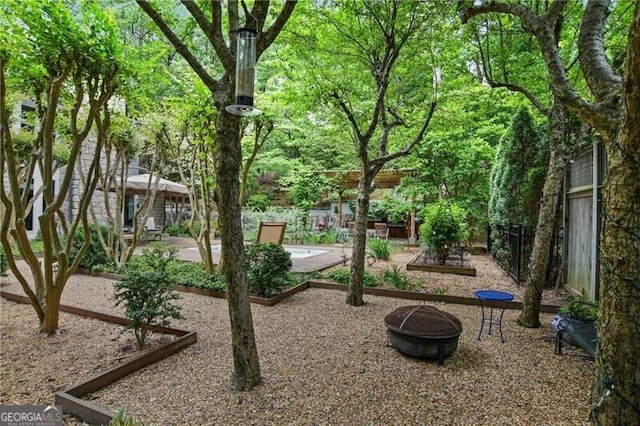 surrounding community featuring a patio and an outdoor fire pit