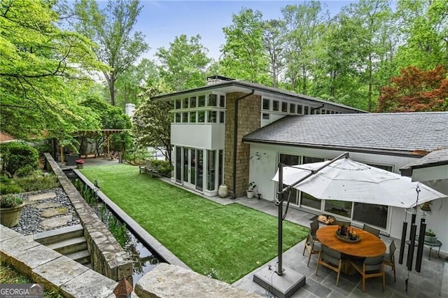 back of house featuring a yard and a patio