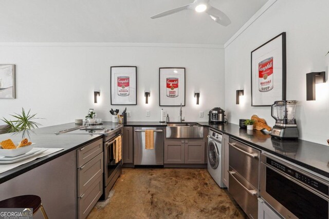 kitchen with sink, washer / dryer, crown molding, kitchen peninsula, and stainless steel appliances