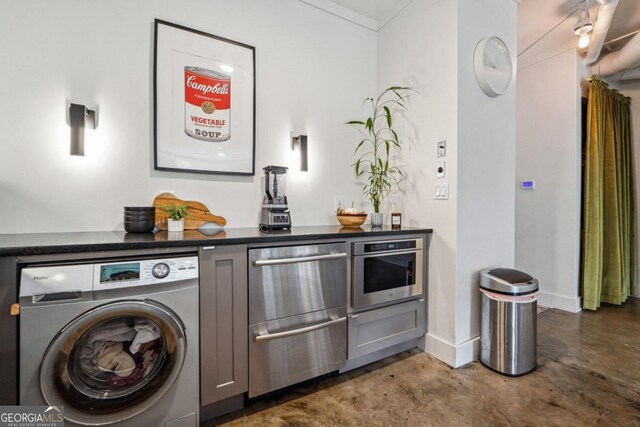 clothes washing area with washer / dryer