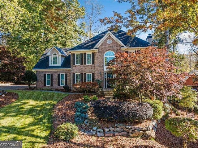 colonial home with a front lawn