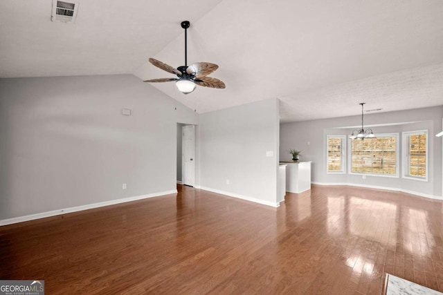 unfurnished living room with lofted ceiling, ceiling fan with notable chandelier, and dark hardwood / wood-style floors