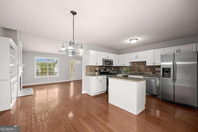 kitchen featuring appliances with stainless steel finishes, dark hardwood / wood-style floors, and white cabinetry