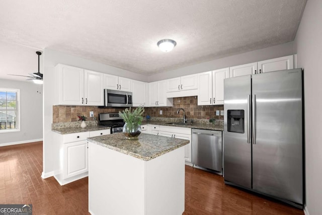 kitchen featuring sink, white cabinets, dark wood-type flooring, and appliances with stainless steel finishes