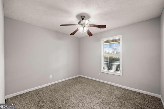 unfurnished room with ceiling fan, carpet floors, and a textured ceiling