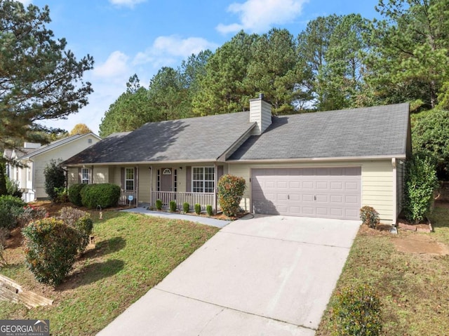 ranch-style home with covered porch, a front yard, and a garage