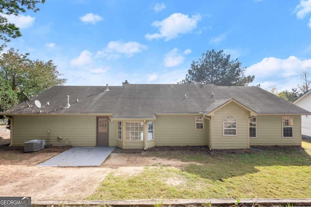 back of property featuring central air condition unit, a patio area, and a yard