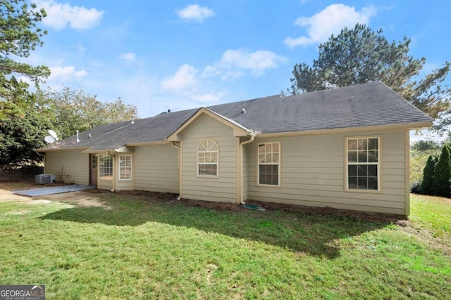 back of property with a patio area, a lawn, and central AC unit