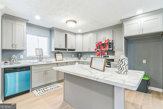 kitchen with dishwasher, sink, light hardwood / wood-style flooring, gray cabinets, and light stone countertops