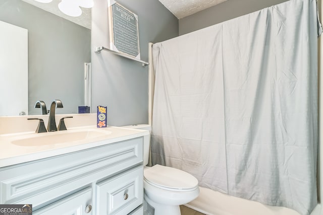 full bathroom featuring vanity, shower / bath combo, toilet, and a textured ceiling