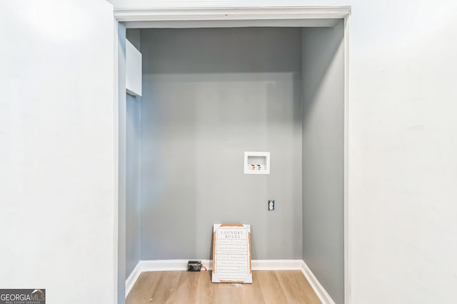 washroom with hardwood / wood-style floors and hookup for a washing machine