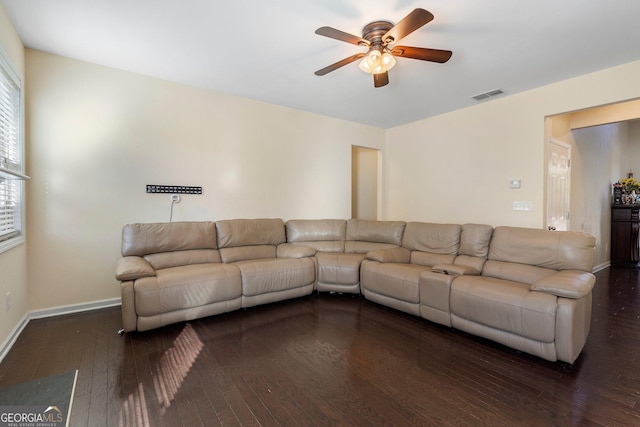 unfurnished living room featuring ceiling fan and dark hardwood / wood-style floors