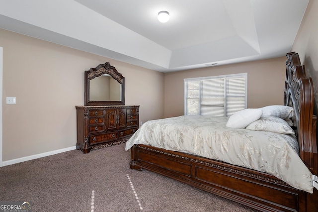 carpeted bedroom featuring a tray ceiling