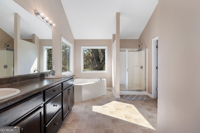 bathroom with plus walk in shower, vanity, and vaulted ceiling