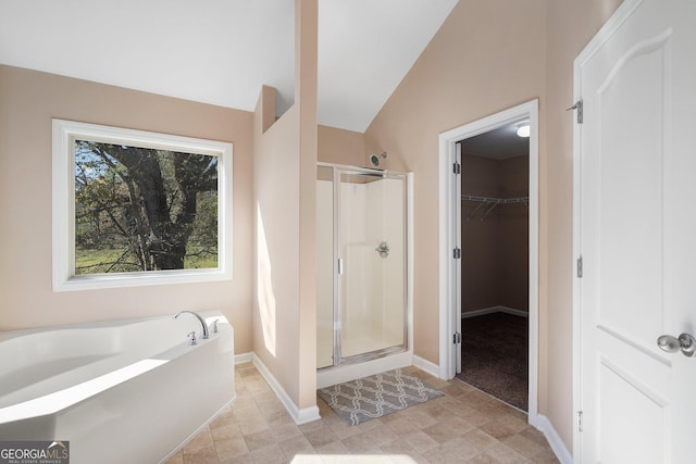 bathroom featuring shower with separate bathtub and vaulted ceiling