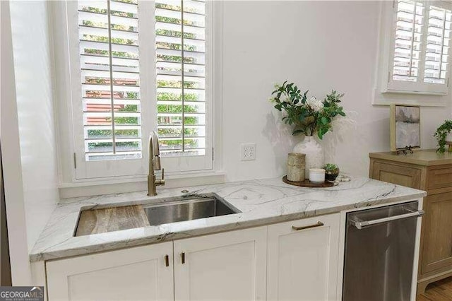 bar with white cabinets, light stone counters, dishwasher, and sink