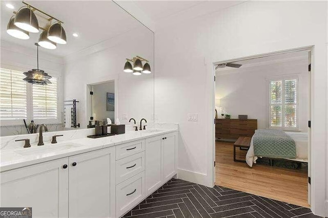 bathroom with vanity and ornamental molding