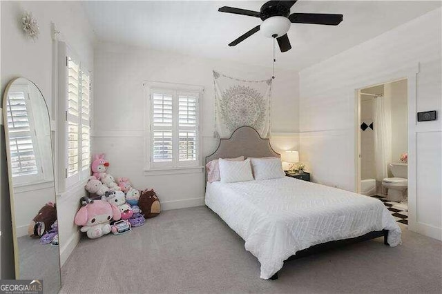 carpeted bedroom featuring ceiling fan and connected bathroom