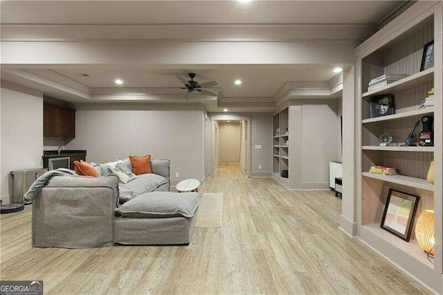 living room with ceiling fan, light hardwood / wood-style floors, and ornamental molding