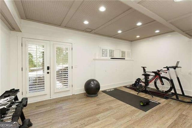 workout area featuring wood-type flooring and french doors