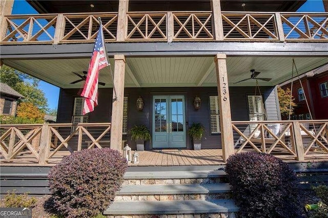 doorway to property with french doors, a porch, and ceiling fan