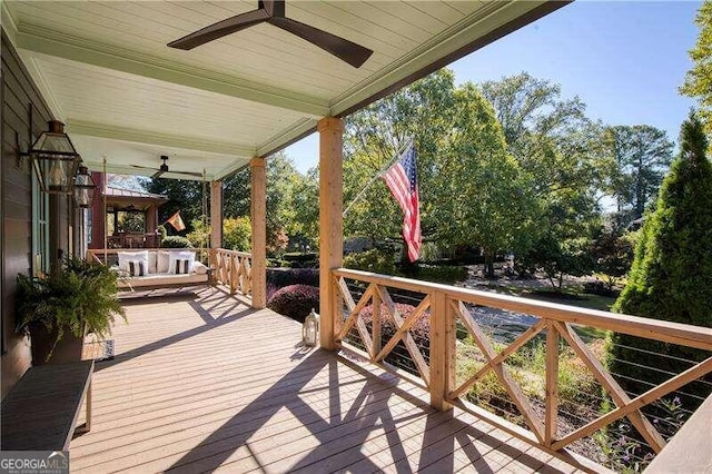 wooden terrace featuring ceiling fan