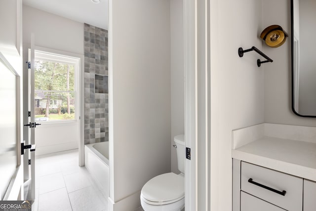 bathroom with tile patterned flooring, vanity, and toilet