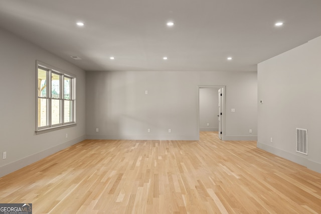 empty room with light hardwood / wood-style flooring