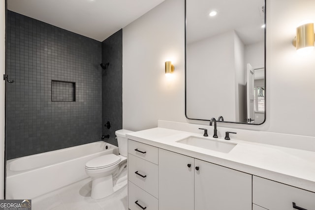 full bathroom featuring vanity, tiled shower / bath combo, and toilet