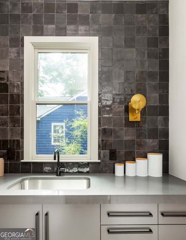 kitchen featuring sink and white cabinets