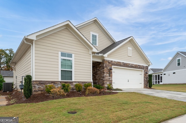 craftsman house featuring central air condition unit, a front yard, and a garage