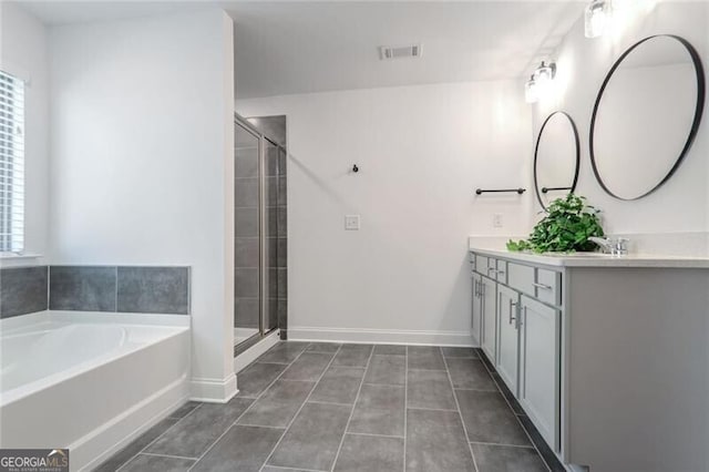 bathroom featuring vanity, independent shower and bath, and tile patterned flooring