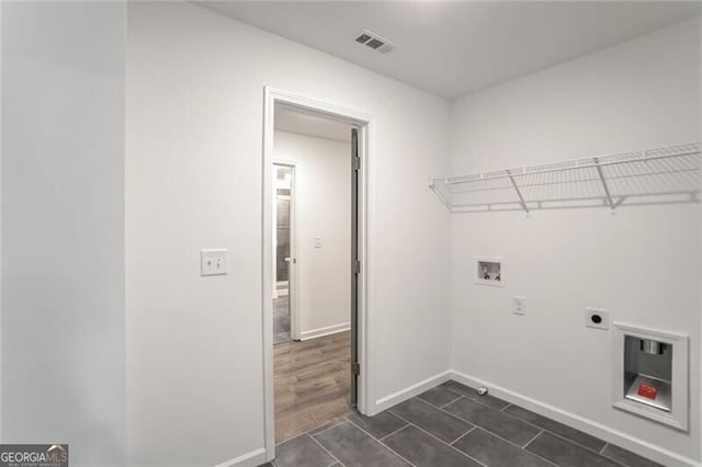 washroom featuring hookup for an electric dryer, washer hookup, and dark hardwood / wood-style flooring