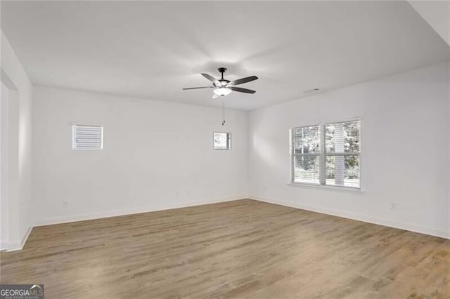 spare room featuring hardwood / wood-style floors and ceiling fan