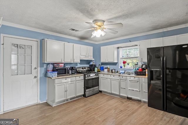 kitchen featuring white cabinets, light wood-type flooring, crown molding, and appliances with stainless steel finishes