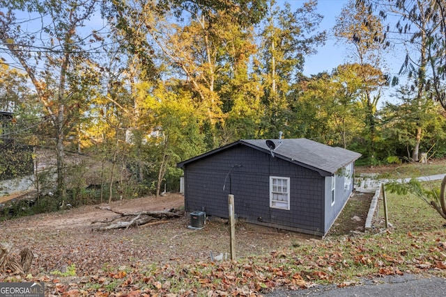 view of side of home with central air condition unit