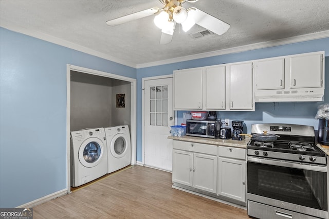 kitchen featuring appliances with stainless steel finishes, light wood-type flooring, crown molding, white cabinets, and independent washer and dryer