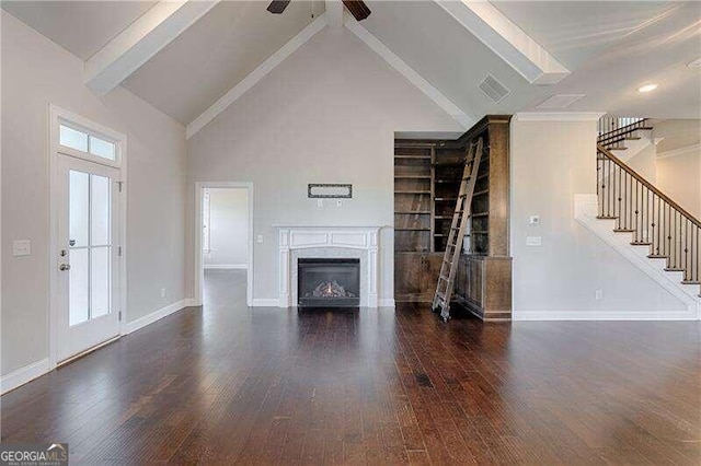 unfurnished living room with dark hardwood / wood-style floors, ceiling fan, beam ceiling, and high vaulted ceiling