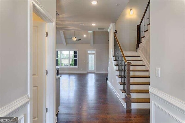 entryway featuring beamed ceiling, dark hardwood / wood-style floors, and ceiling fan