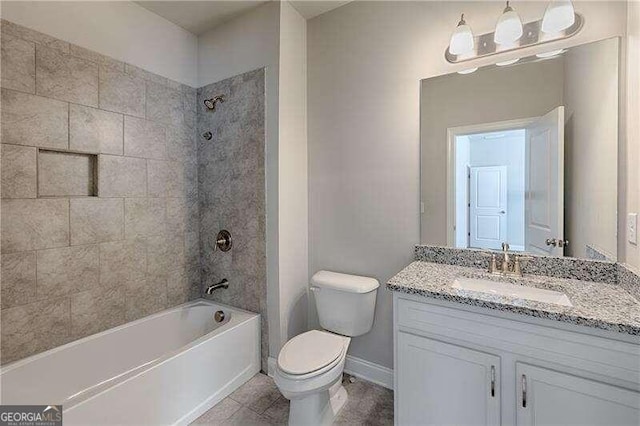 full bathroom with tile patterned floors, vanity, tiled shower / bath combo, and toilet