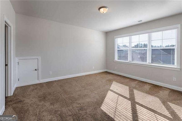 spare room featuring carpet