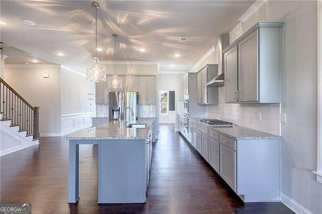 kitchen featuring gray cabinetry, stainless steel appliances, hanging light fixtures, and dark wood-type flooring