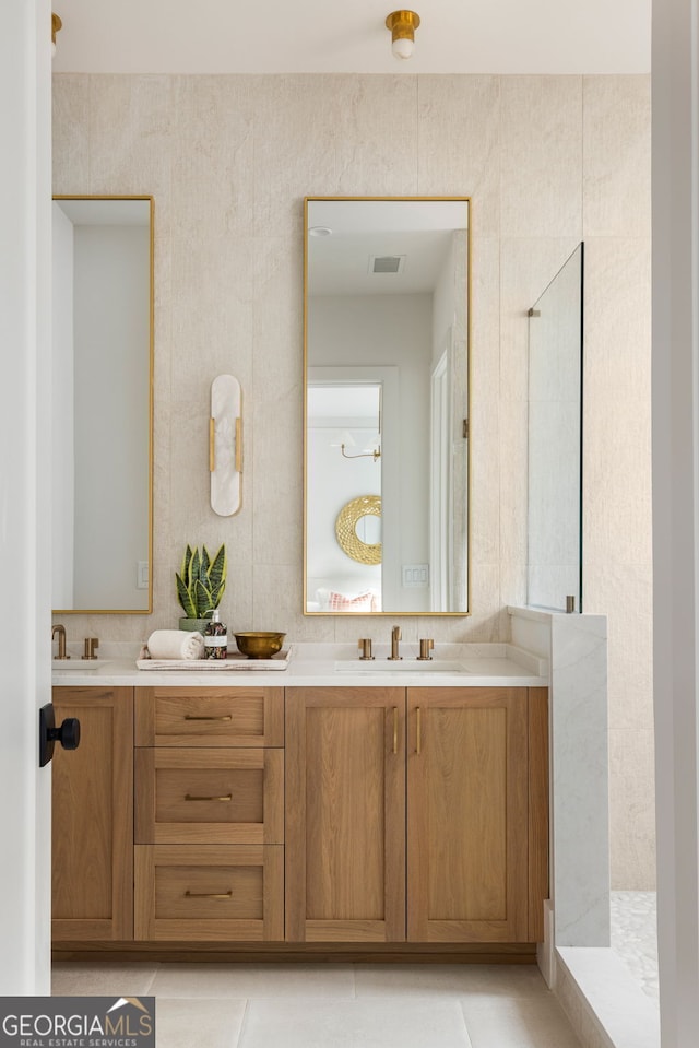 bathroom featuring vanity, tile patterned floors, and walk in shower