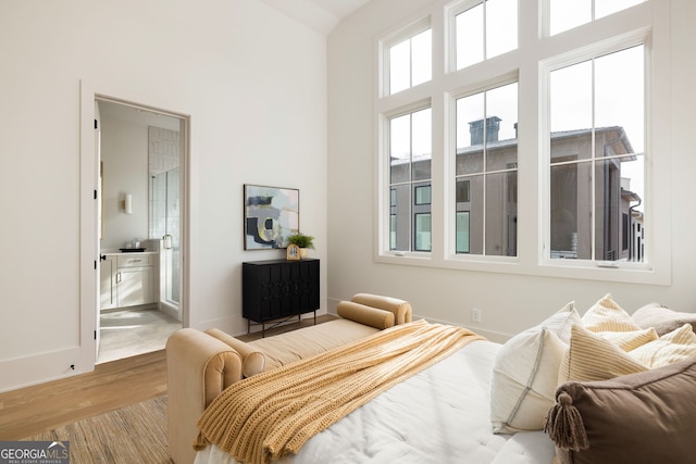 bedroom featuring wood-type flooring and ensuite bathroom