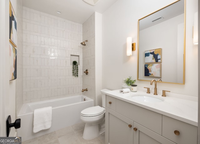 full bathroom with vanity, tile patterned flooring, tiled shower / bath combo, and toilet