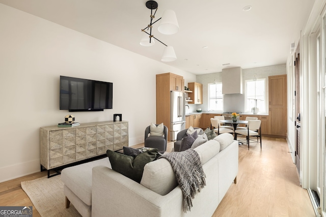 living room with sink and light hardwood / wood-style flooring