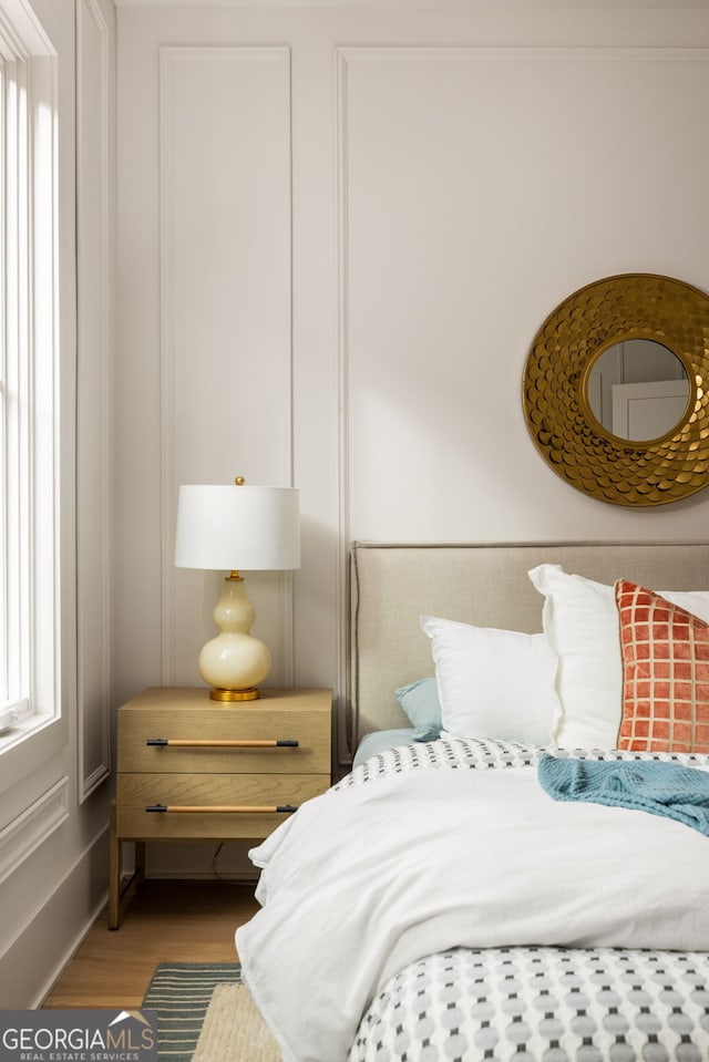 bedroom with wood-type flooring