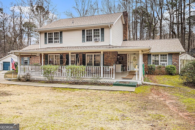 view of front facade featuring cooling unit, a porch, and a front yard