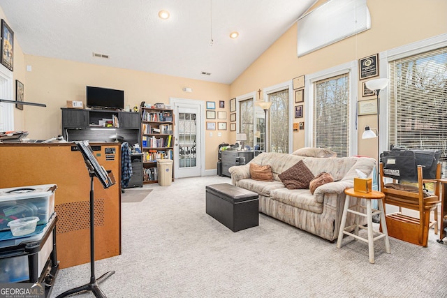 carpeted living room featuring vaulted ceiling