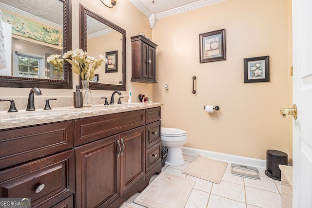 bathroom featuring vanity, tile patterned flooring, crown molding, and toilet